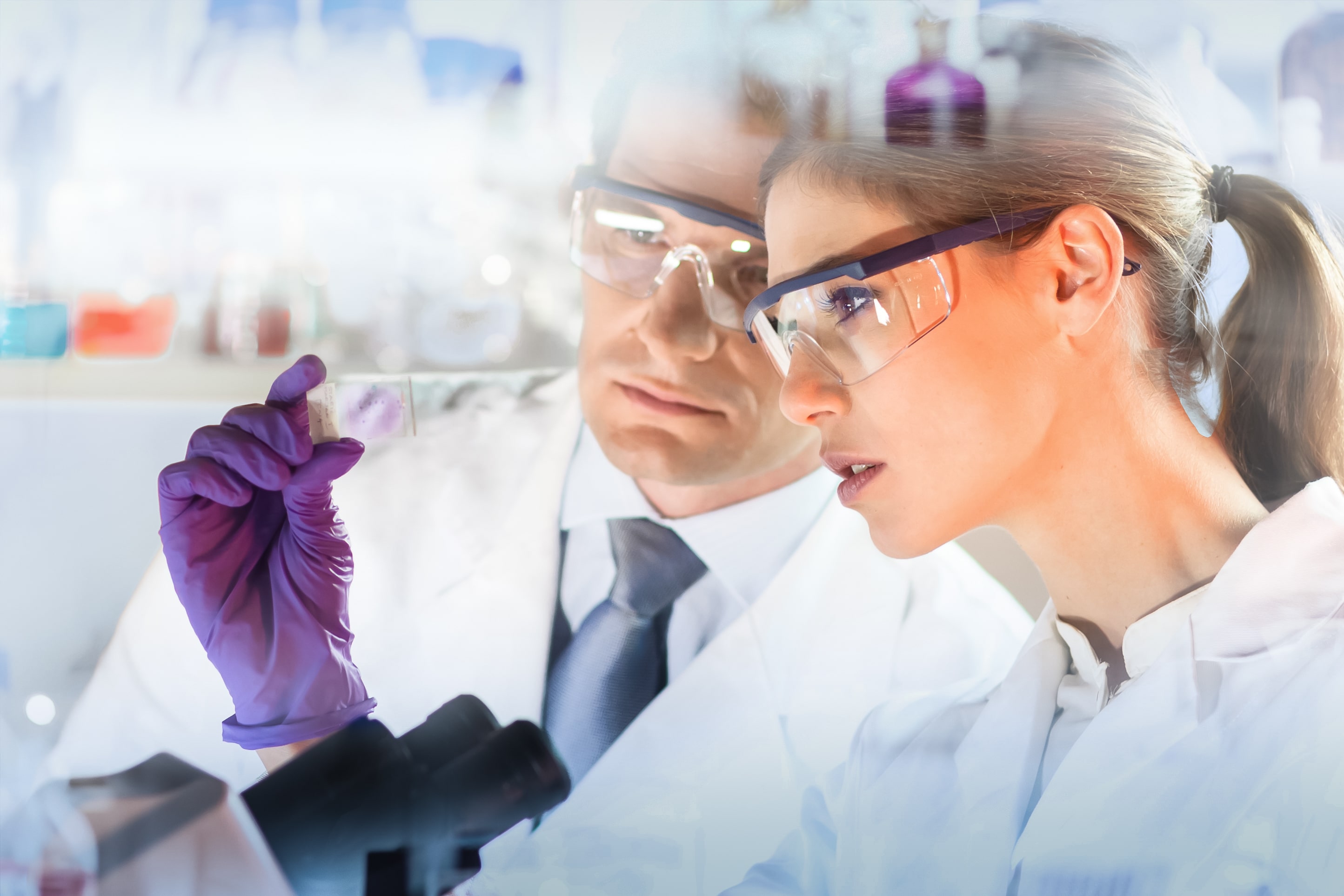 Two laobratory technicians looking at lab sample